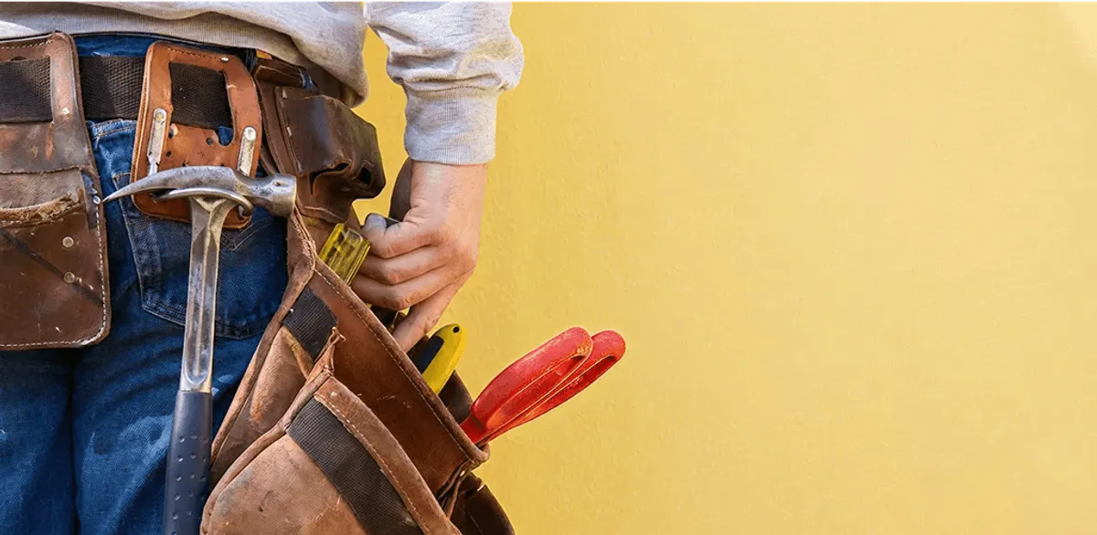 Handyman with tool belt ready for home repairs and maintenance in Akron, OH